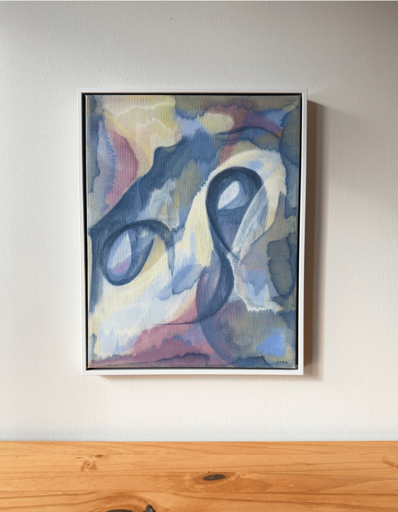 Abstract painting on a wall above a wooden surface