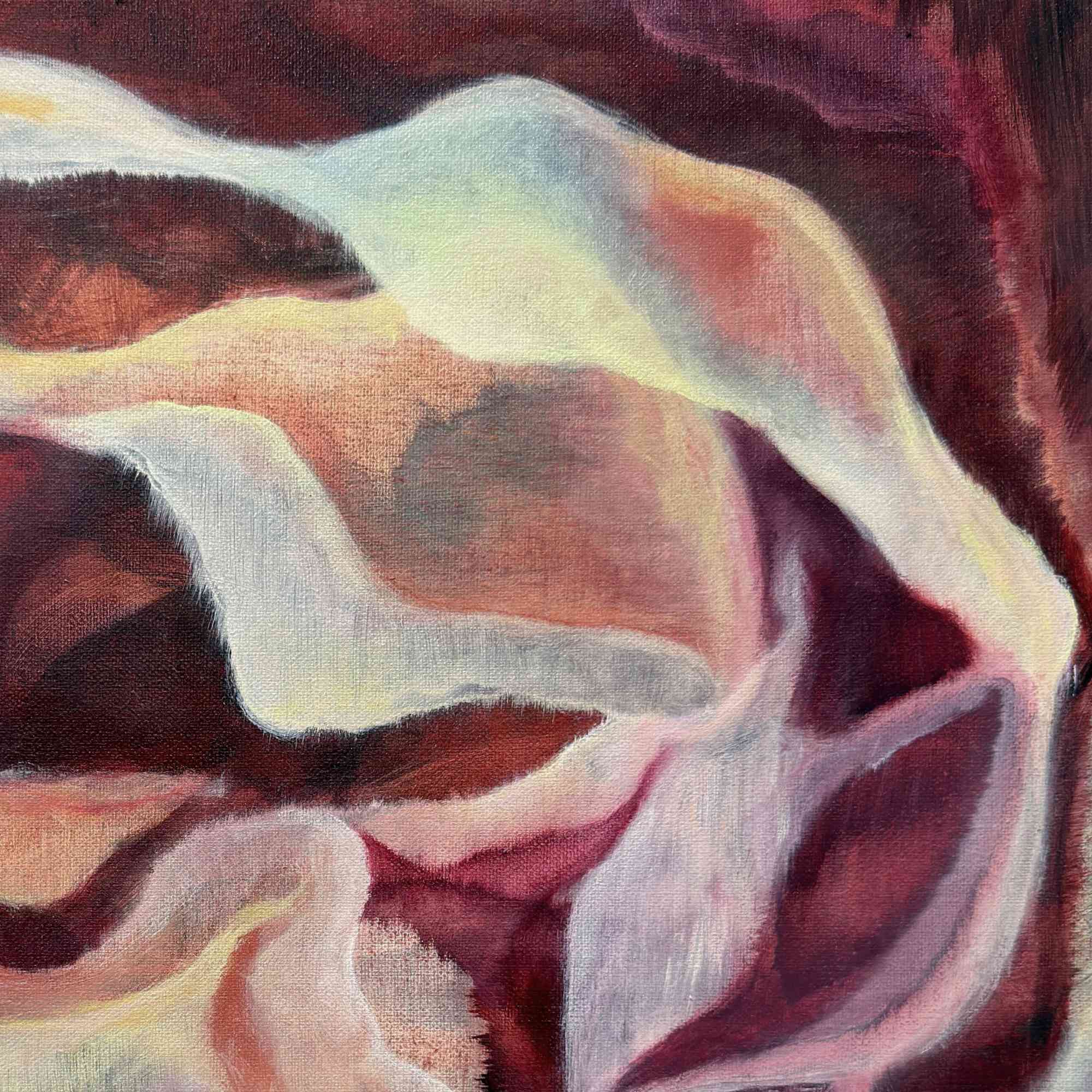 Close-up of a textured fabric with wavy patterns in red, white, and pink.